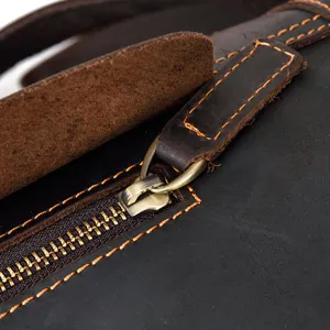 Detail view of vintage crazy horse leather chest bag, durable metal zipper and stitching.