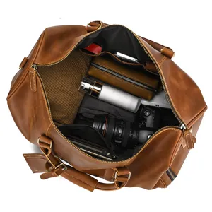 Detail view of open vintage crazy horse leather travel duffel bag with large capacity.