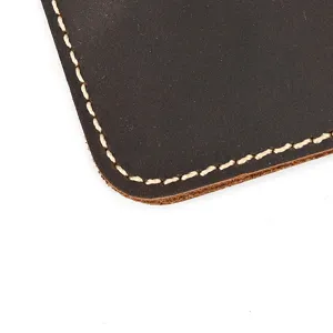Close-up detail of vintage crazy horse leather watch pouch with contrast stitching.