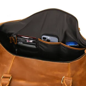 Interior detail of vintage crazy horse leather travel duffel bag with multi-pocket storage.