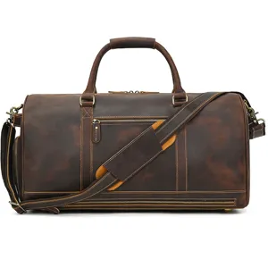 Vintage crazy horse leather duffel bag detail showcasing sturdy metal zippers and strap.