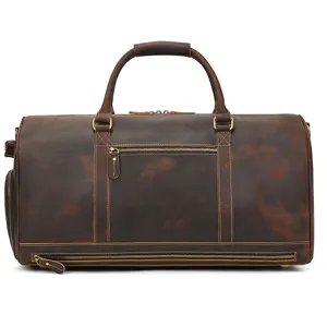 Vintage leather travel duffel bag detail with bottom shoe compartment and sturdy metal zippers.