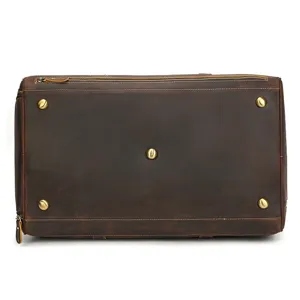 Genuine leather retro travel duffel bag bottom detail view with metal feet and secure zipper.