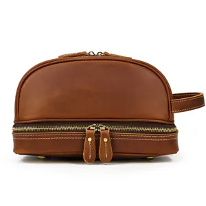 Detailed view of the brown leather vintage double layer toiletry bag zipper and handle hardware.
