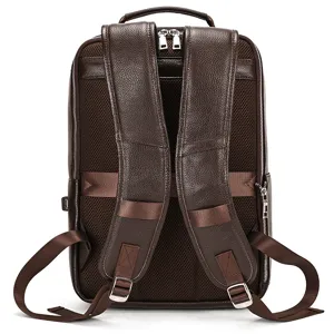 Detailed close-up of brown leather backpack back straps and breathable mesh panel.