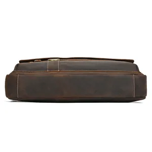 Vintage brown leather briefcase bottom detail view, premium cowhide business messenger bag