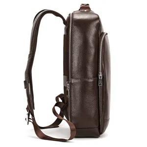 Side view detail of the brown leather backpack showing sturdy zipper pockets and structure.