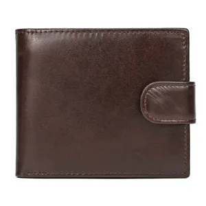 Close-up detail of genuine leather short wallet with snap button closure in dark brown color.
