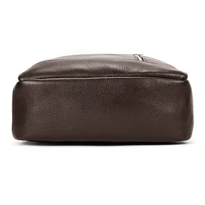 Detailed view of the genuine leather business backpack in dark brown, showing fine texture.