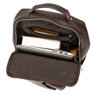 Detail view of the brown leather backpack interior, showing spacious capacity for laptop.