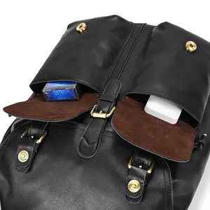 Close-up view of genuine leather backpack featuring dual front pockets and brass magnetic snaps.