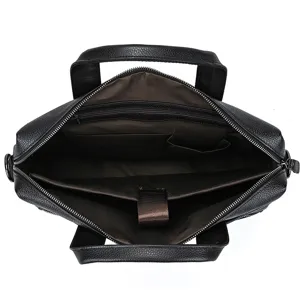 Top-down interior detail showing compartments and brown lining of the black leather business bag.