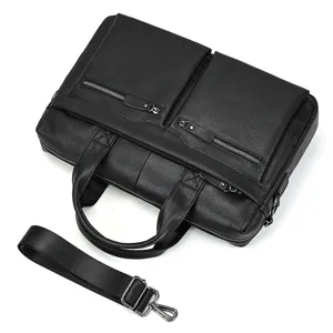 Close-up detail of the black leather briefcase, featuring durable metal zippers and strap.