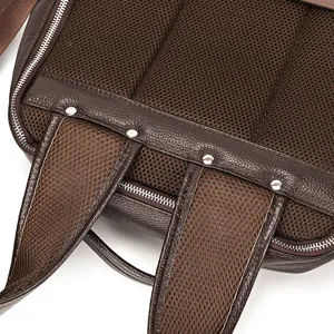 Detailed view of genuine leather men's backpack back with breathable mesh and metal rivets.