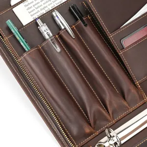 Detail view of genuine leather A4 folder interior with pen slots and card holders for business.