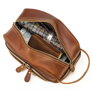 Detailed view of genuine leather double layer toiletry bag interior capacity vintage design.