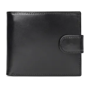 Detailed view of black leather wallet showing snap closure and card slots texture.