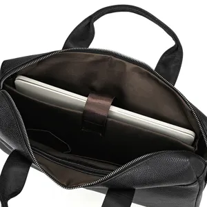 Interior detail view of black leather mens laptop briefcase, showing spacious compartment.