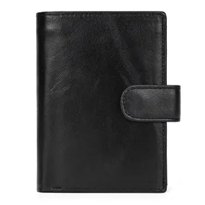 Black leather trifold wallet detail showing premium texture and secure snap closure design.