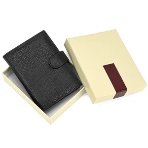 Detail view of black genuine leather trifold wallet featuring snap closure and gift box.