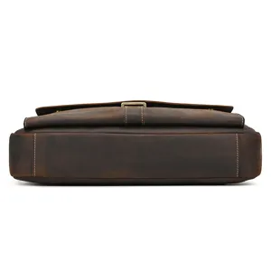 Closeup detail of vintage brown crazy horse leather briefcase bottom showing premium texture.