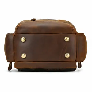 Detailed view of genuine leather backpack bottom with metal feet, durable cowhide design.
