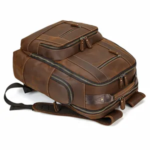 Vintage brown genuine leather backpack detail shot, multi-pocket travel book bag.