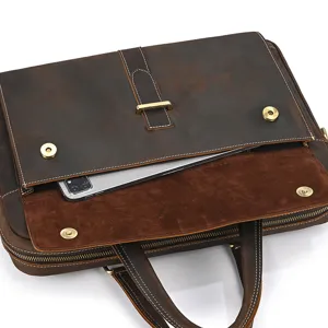 Genuine leather vintage briefcase detail showing laptop compartment and durable metal hardware