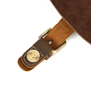 Genuine leather backpack buckle detail showing vintage hardware and fine stitching.