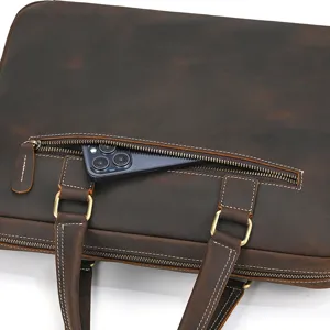 Detail shot of vintage crazy horse leather briefcase front zipper pocket with phone storage.
