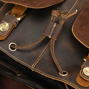 Vintage crazy horse leather backpack detail view with durable metal hardware and drawstrings.