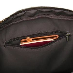 Close-up detail shot of genuine leather briefcase interior showing dark lining and secure zipper pocket.