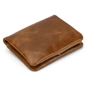 Close-up detail of vintage brown leather wallet, showing fine texture and neat stitching.