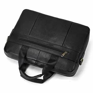 Detail shot of black genuine leather business briefcase zipper and sturdy handle.