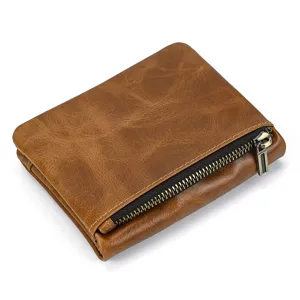 Vintage brown leather wallet detail shot showing premium cowhide texture and metal zipper.