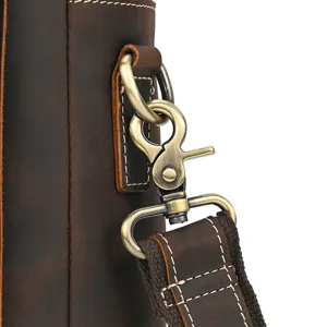 Detail close-up of vintage crazy horse leather shoulder bag hardware in antique bronze finish.