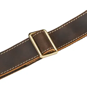 Close-up detail of genuine crazy horse leather backpack strap with metal buckle.