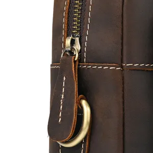 Close-up detail of vintage crazy horse leather briefcase, showing premium stitching and zipper.