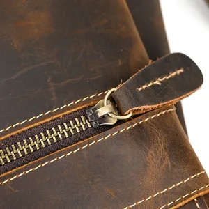 Detailed shot of vintage crazy horse leather backpack zipper and contrast stitching hardware.