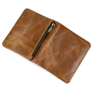 Close-up detail of retro genuine leather men wallet with diagonal zip pocket and fine texture.