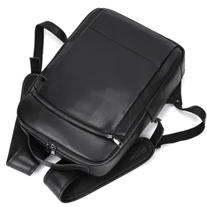 Detailed view of the black genuine leather business backpack showing fine texture and zippers.