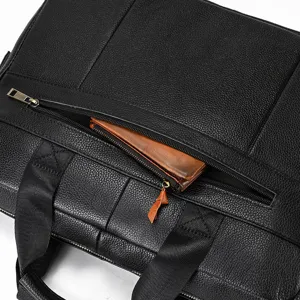 Black leather briefcase detail showing zipper pocket and premium genuine leather texture