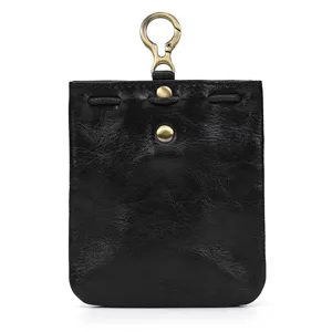 Handmade black vintage vegetable tanned leather coin purse with metal hook detail, detail shot.