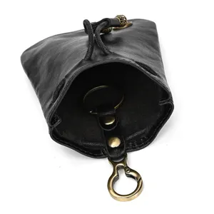 Handmade black leather drawstring coin purse with retro brass keyring and mini change bag.