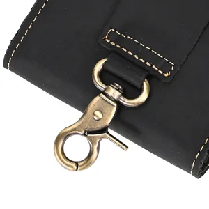 Vintage crazy horse leather phone pouch detail, antique brass lobster hook, durable stitching.