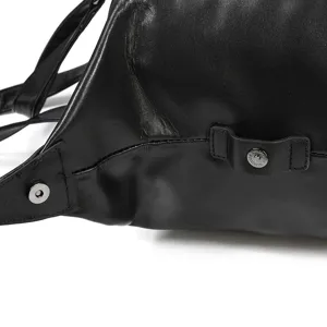 Black leather duffel bag detail showing premium texture, reinforced strap and metal snap buttons.