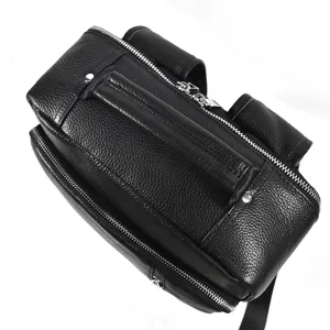 Close up detail view of black leather backpack zipper and smooth texture, premium quality.