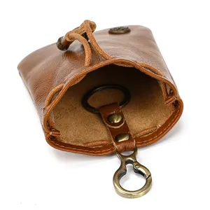 Retro genuine leather coin purse mini key pouch with drawstring and metal keyring hook detail.
