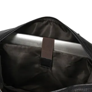 Interior detail shot of men's leather travel bag with laptop compartment and elastic strap.
