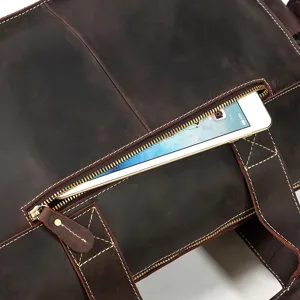 Detail view of genuine leather business bag featuring secure zipper pocket and sturdy stitching.